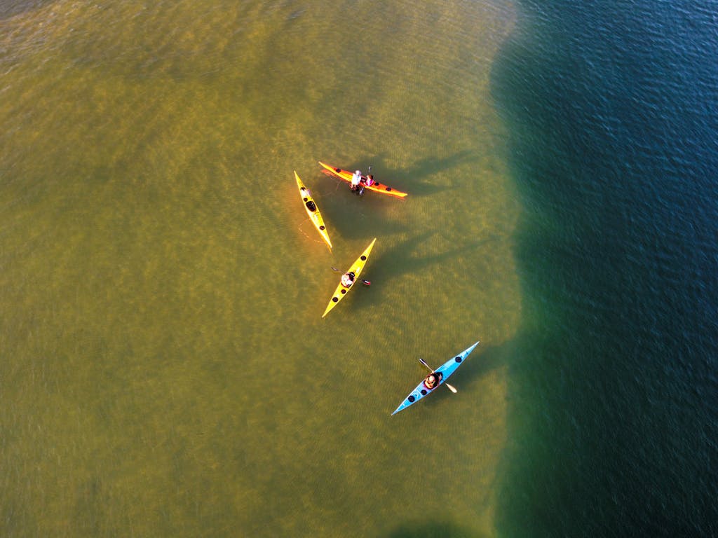 Drone shot capturing vibrant kayaks on the calm waters of Ashdod, Israel, offering a vibrant and active scene.
