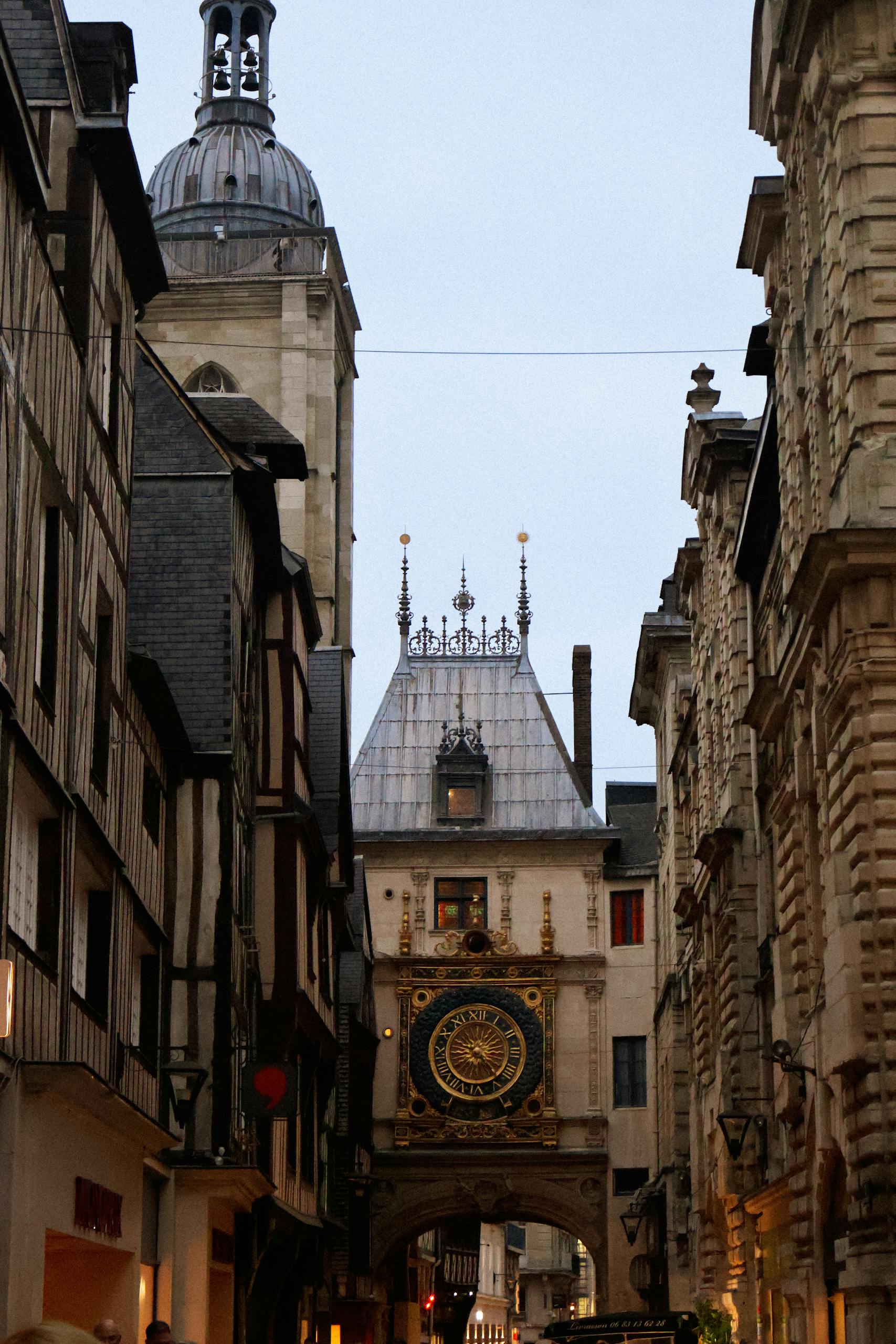 Medieval clock tower architecture in Rouen's historic street.